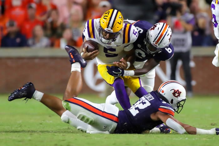 Auburn Tigers cornerback Keionte Scott (6) wraps up LSU Tigers quarterback Jayden Daniels (5) from behind during the game between the LSU Tigers and the Auburn Tigers at Jordan-Hare Stadium on Oct. 1, 2022.